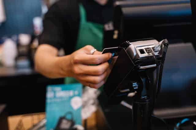 A cashier swiping a card to accept payment